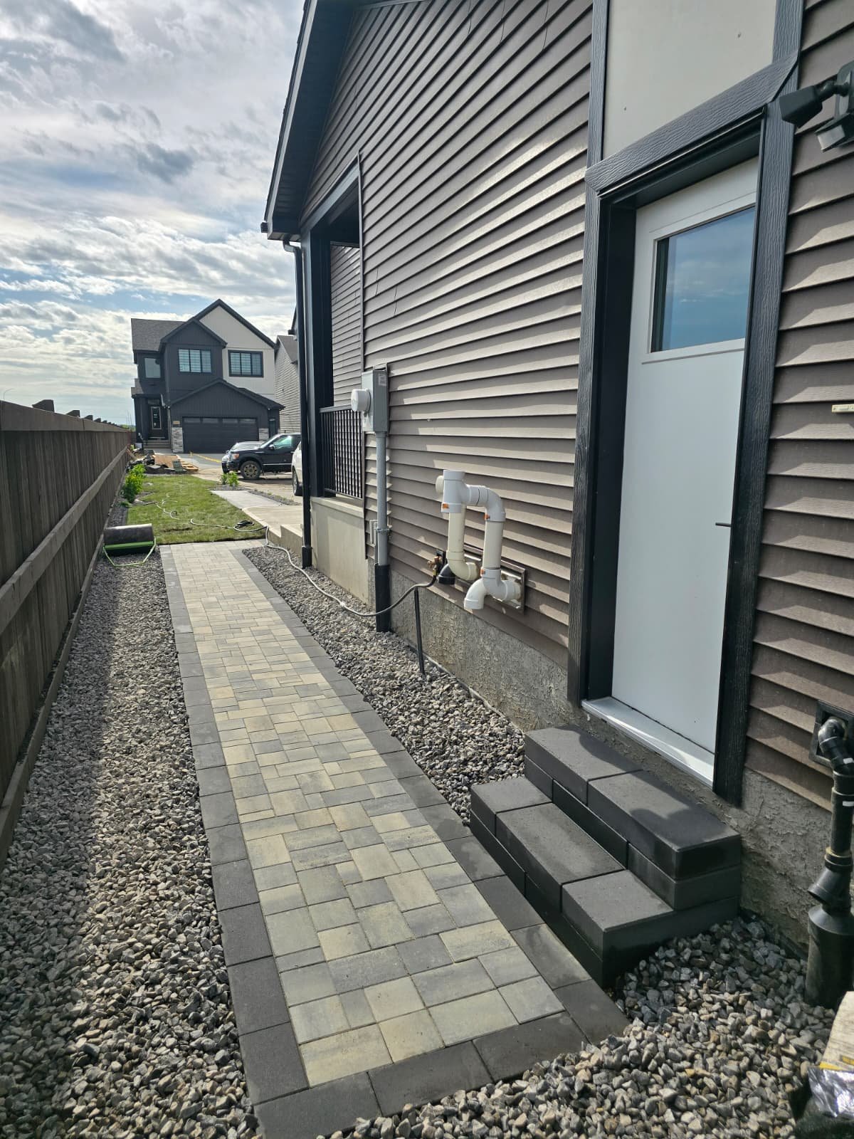 Stone paver sideyard walkway with gravel border — Edmonton