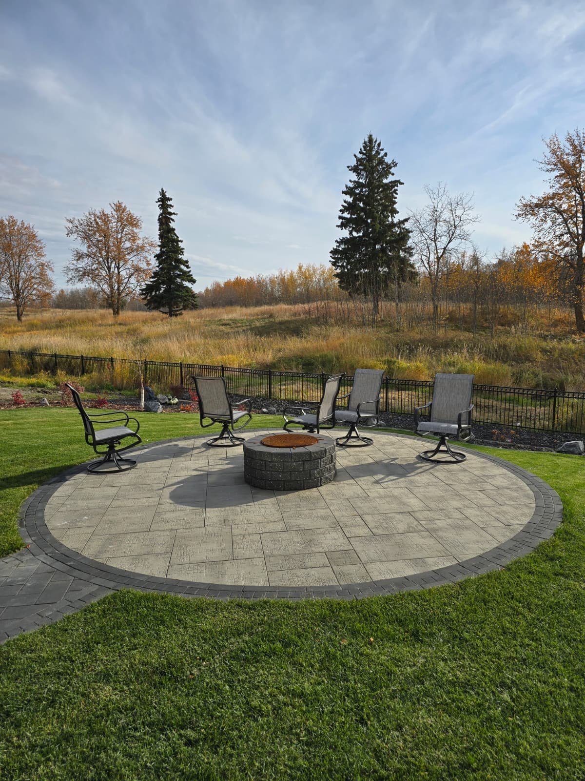 Round stone paver firepit patio — Edmonton