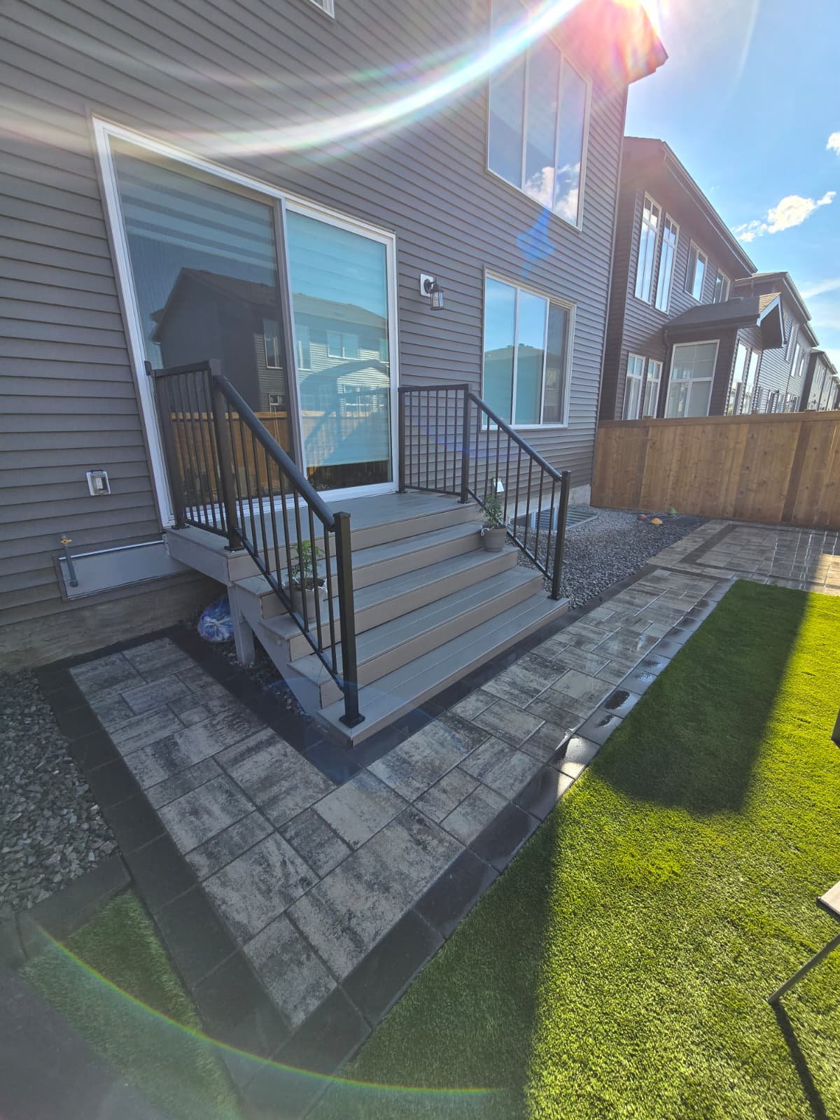 Backyard patio with deck stairs — Edmonton