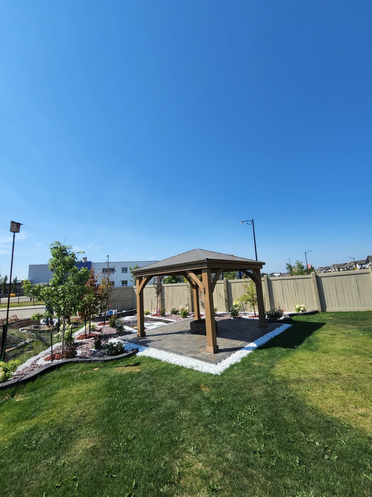 Wood pergola gazebo over paver pad — Edmonton